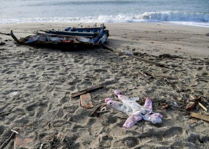 A photograph taken on February 28, 2023 shows a onesie and pieces of wodd washed up on the beach, two days after a boat of migrants sank off Italy’s southern Calabria region, in Steccato di Cutro, south of Crotone.